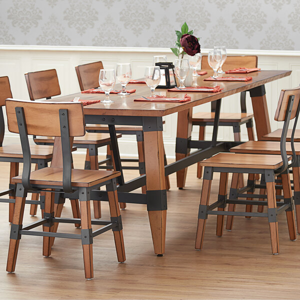 The Lancaster Table & Seating wooden trestle table base for a rectangular table in a restaurant dining area.