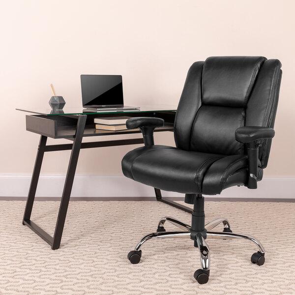 A black Flash Furniture Hercules Big & Tall mid-back office chair with wheels next to a glass desk.
