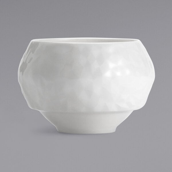 A white porcelain bouillon bowl with a textured rim.