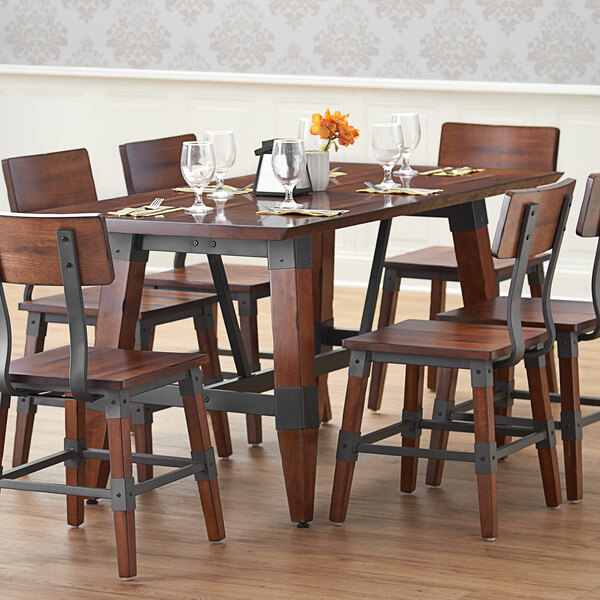 A Lancaster Table & Seating dining table with a wooden surface and trestle legs.