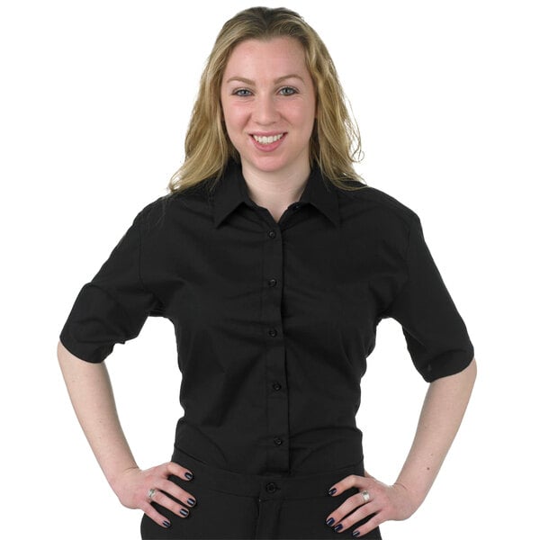 A woman wearing a black Henry Segal short sleeve dress shirt.
