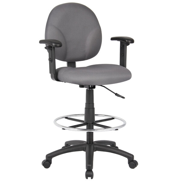 A gray Boss drafting stool with adjustable arms and metal base with footring.