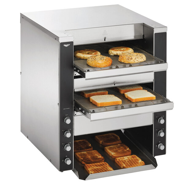 A Vollrath dual conveyor toaster with bread on it.