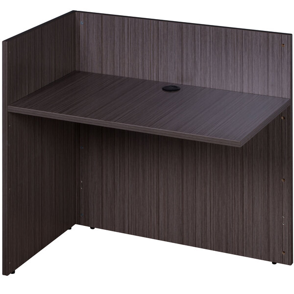 A Boss Driftwood laminate reception return desk with a black surface, shelf, and drawer.