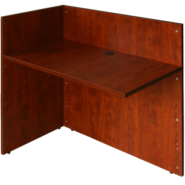 A Boss cherry laminate reception return desk with a desk top and shelf.