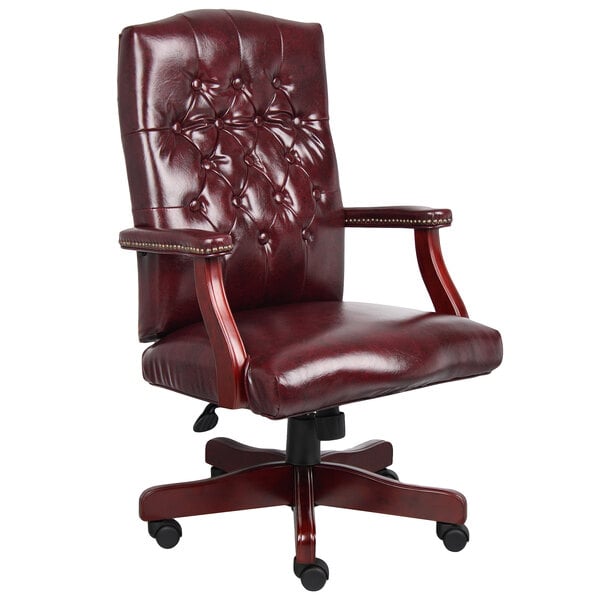 A red leather Boss office chair with arms and wheels.