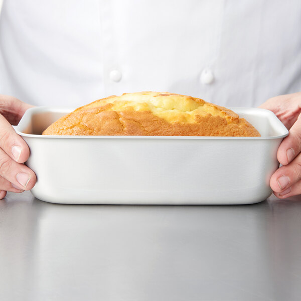 A loaf of bread in a Vollrath Wear-Ever white bread pan.
