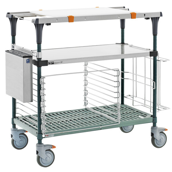 A Metro stainless steel cart with two shelves and a tray on top.