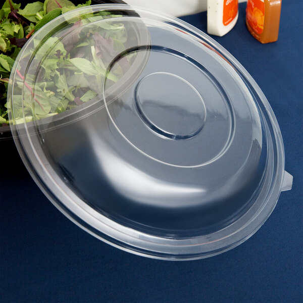 A clear plastic Fineline dome lid on a salad bowl.