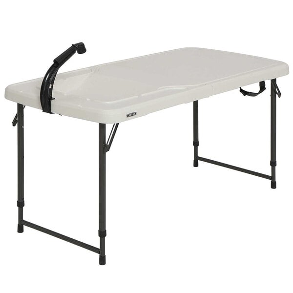 A white rectangular plastic folding table with a black handle.