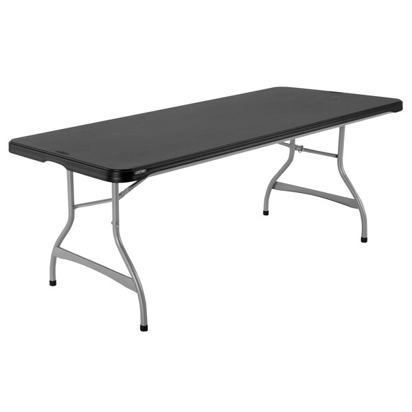 A rectangular black Lifetime folding table with silver legs.