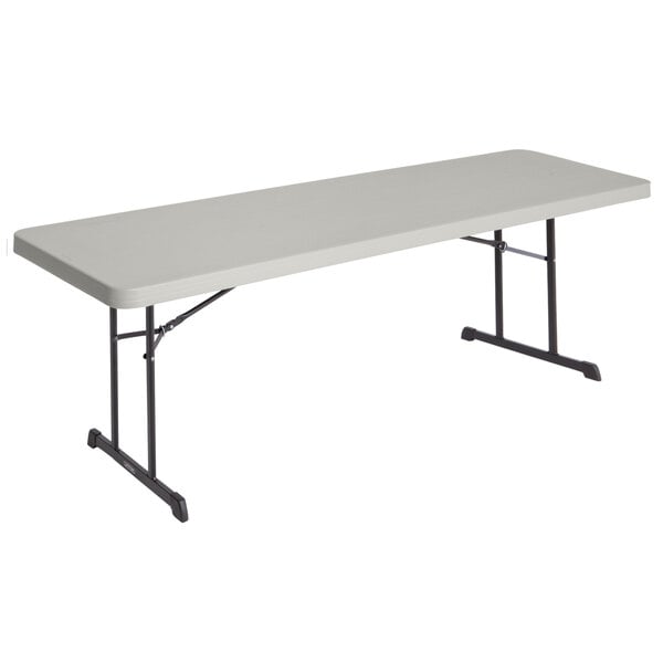 A rectangular putty folding table with a black frame.