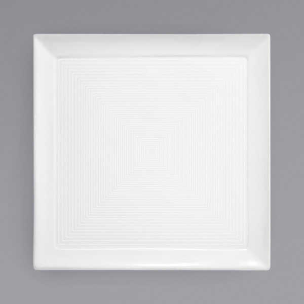 A white square porcelain plate with a spiral pattern.