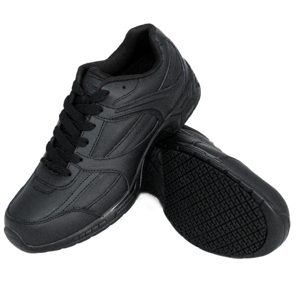 A pair of black Genuine Grip athletic shoes with laces.