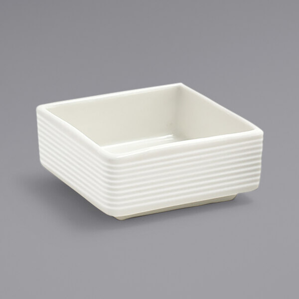 A white square Front of the House porcelain ramekin with ribbed lines.
