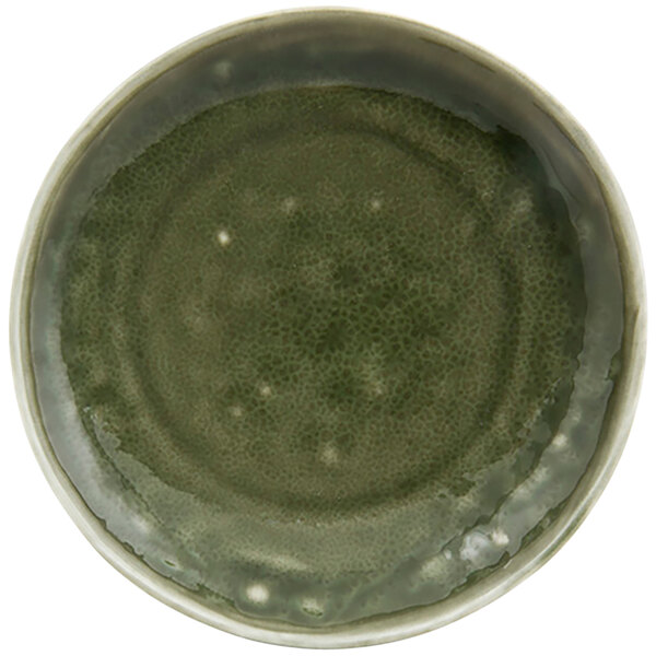 A green porcelain plate with a circular pattern.