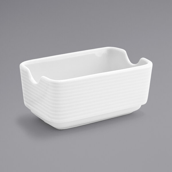 A white rectangular porcelain sugar caddy with a straight edge.
