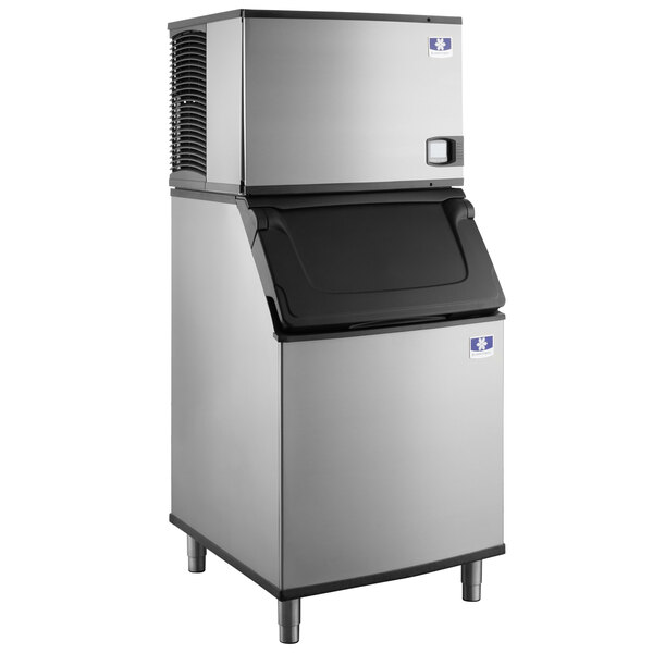 A stainless steel Manitowoc water cooled ice machine with a black top.