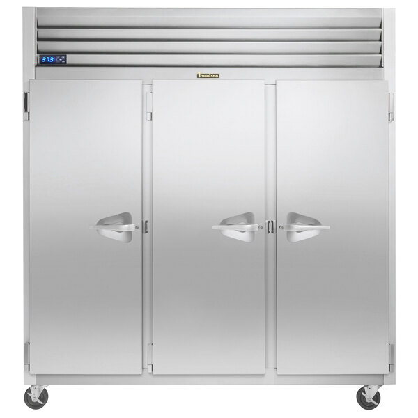 A large Traulsen reach-in refrigerator with three white doors and white handles.