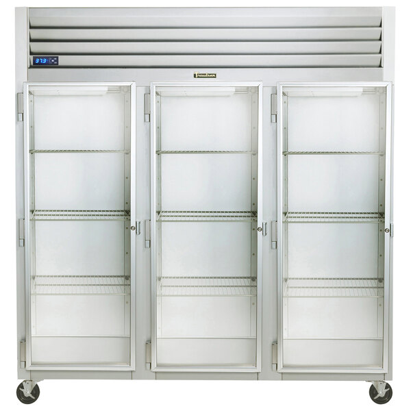 A white Traulsen G Series reach-in refrigerator with three glass doors on wheels.