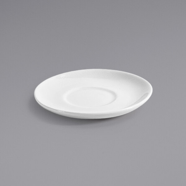 A white Front of the House Kiln porcelain saucer on a gray surface.