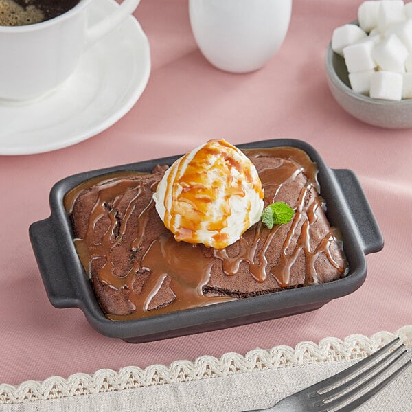 A brownie with ice cream and Monin Sea Salt Caramel Toffee Sauce on top.