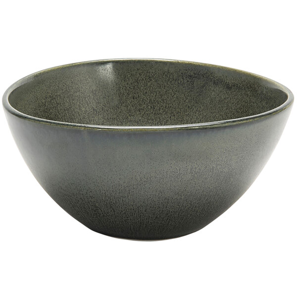 A Front of the House Kiln porcelain bowl with a speckled surface and a white background with a sage gray rim.