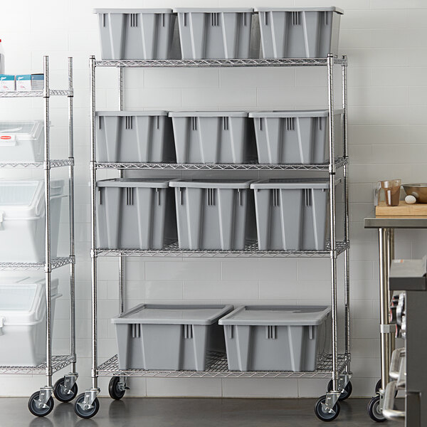 A Rubbermaid grey plastic Palletote container shelving kit on a metal shelf.