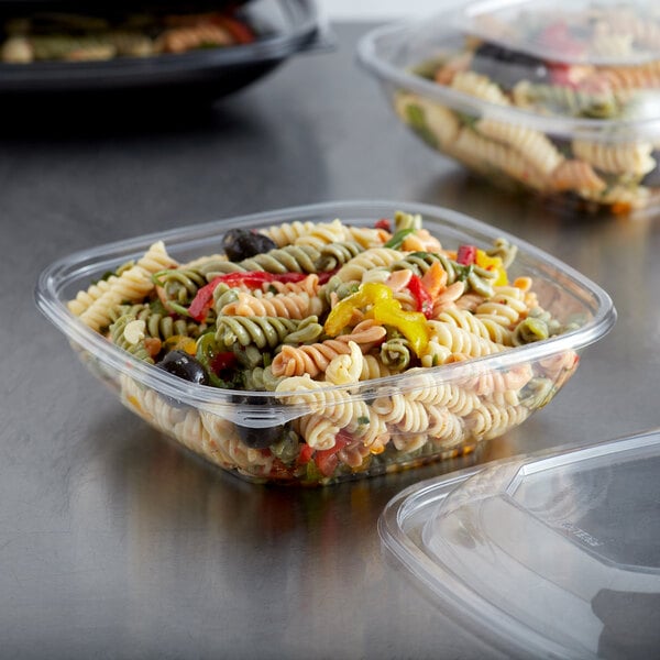 A clear Fineline plastic bowl filled with pasta and vegetables.