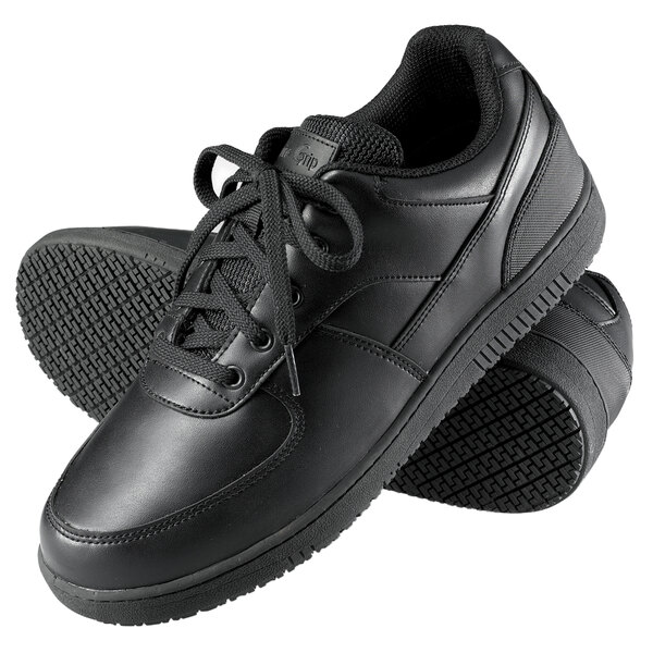 A pair of Genuine Grip black leather athletic shoes with laces.