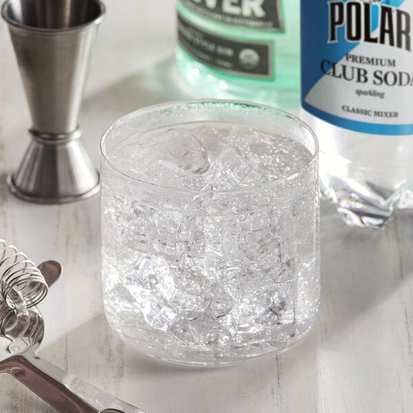 A glass of ice and a bottle of Polar club soda.