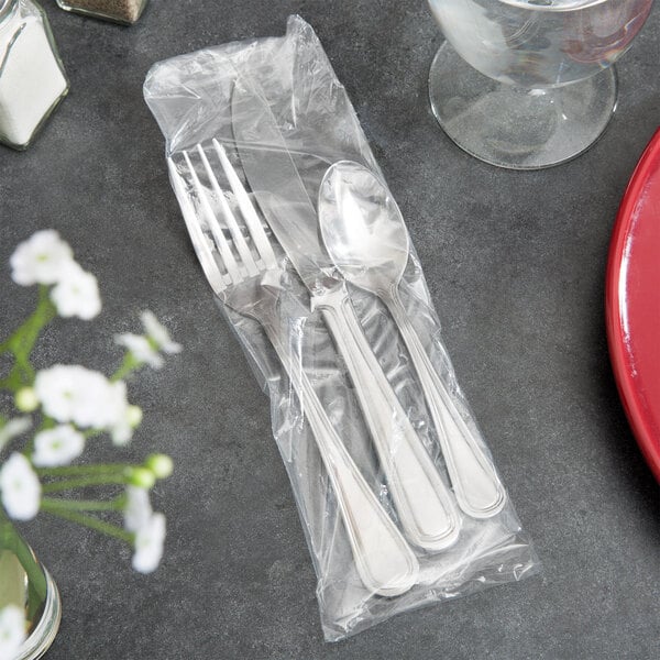 A spoon and fork in a plastic bag.