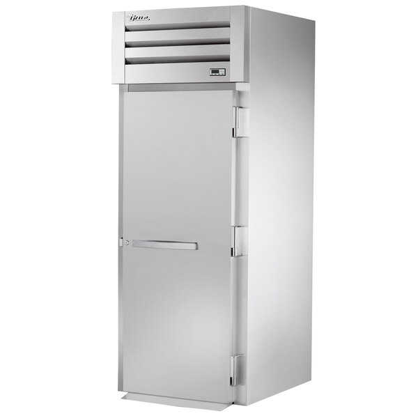 A silver True Spec Series roll-in freezer with a white door and silver handles.