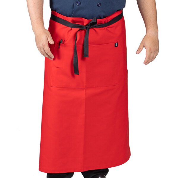 A person wearing a red Uncommon Chef bistro apron with black webbing.