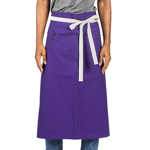 A person wearing a purple Marvel bistro apron with natural webbing.