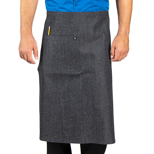 A man wearing a grey Uncommon Chef West End Bistro apron with red webbing.