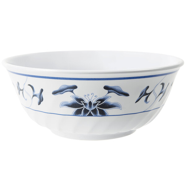A white fluted melamine bowl with blue lily designs.