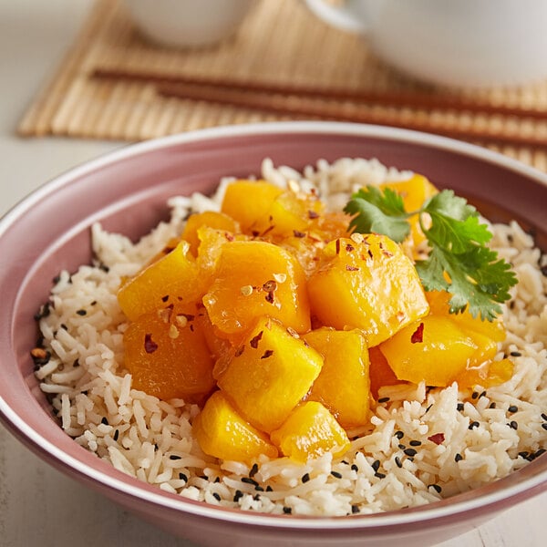 A bowl of rice with 30 lb. IQF chunks of organic mangoes.