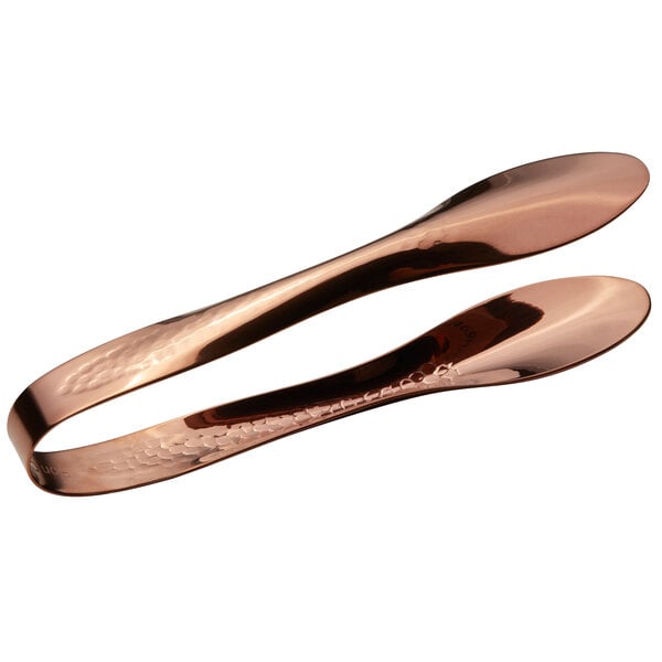 A pair of Bon Chef rose gold stainless steel tongs with a hammered finish on the ends.