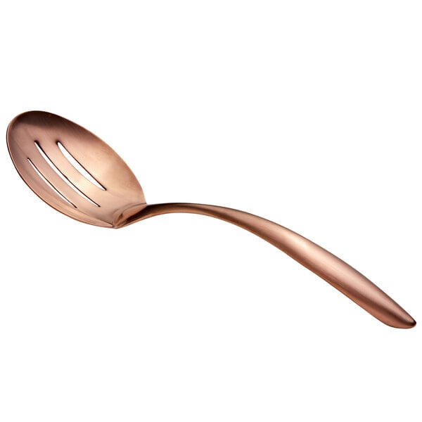 A close-up of a Bon Chef rose gold matte slotted serving spoon with a hollow cool handle.