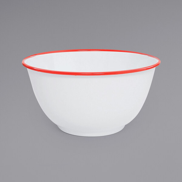 A white Crow Canyon Home enamelware bowl with a red rim.