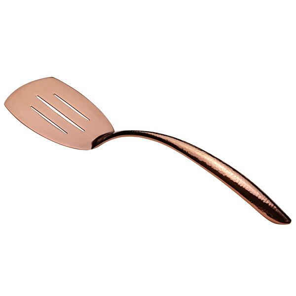 A close-up of a Bon Chef rose gold slotted serving turner with a hollow handle.