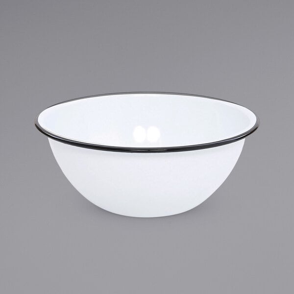 A white enamelware bowl with a black rim.