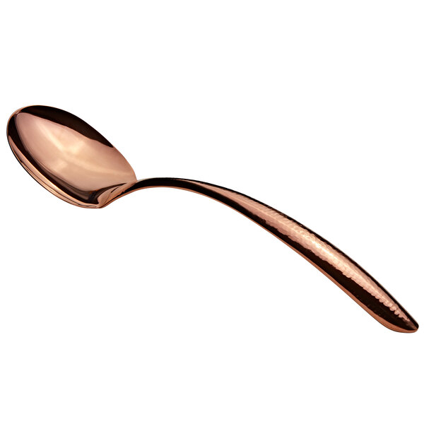 A close-up of a Bon Chef stainless steel serving spoon with a rose gold hammered handle.