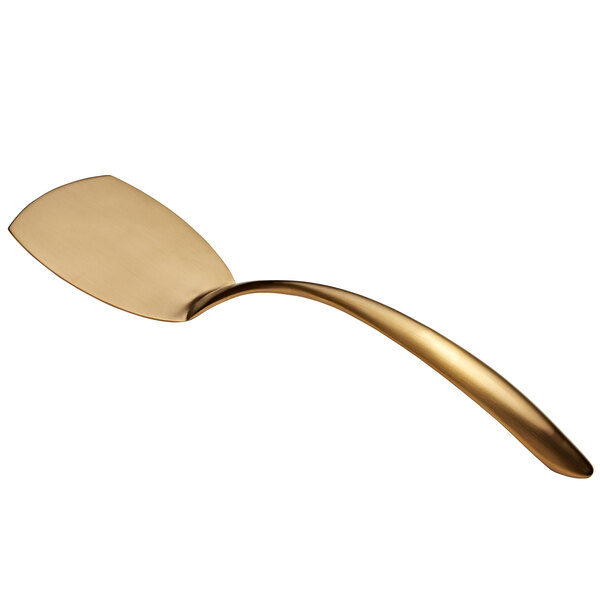 A curved stainless steel serving turner with a gold matte handle.