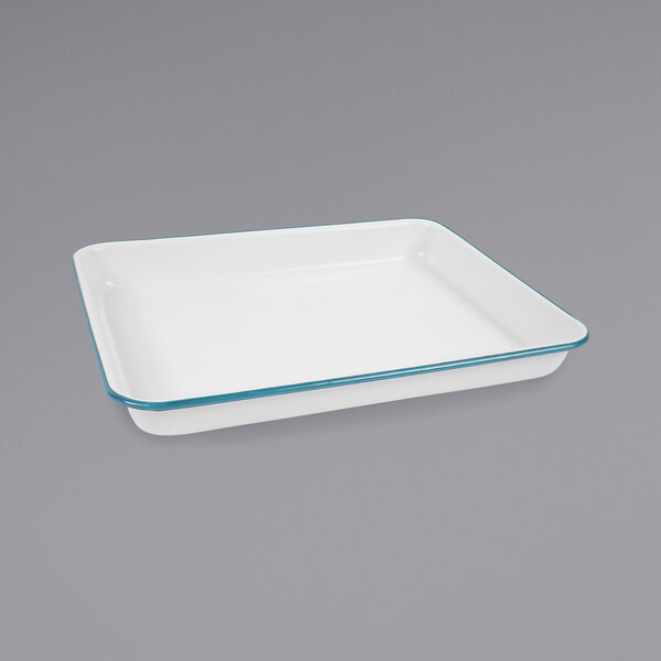 A white rectangular baking dish with turquoise trim.
