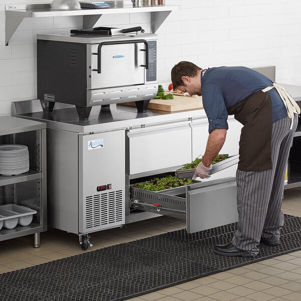 a person putting food in a drawer