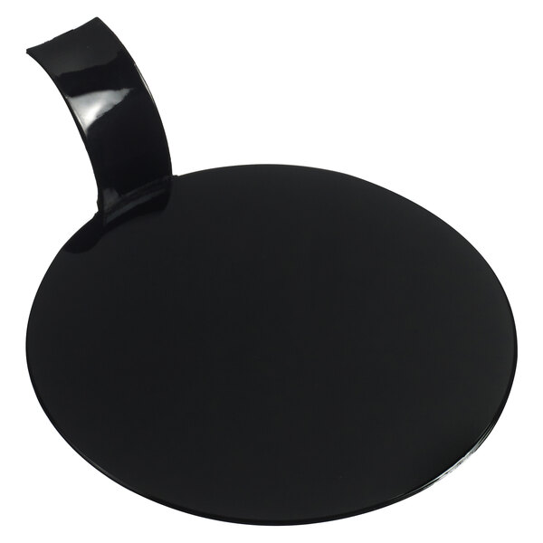 A black circular object with a curved handle.