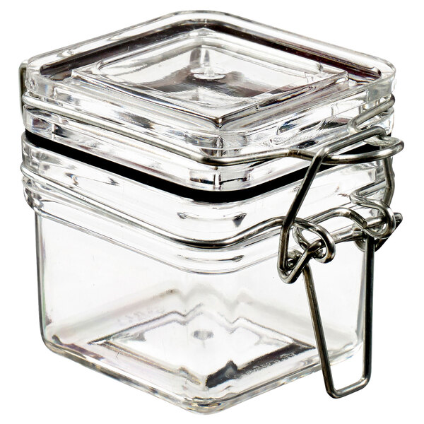 A clear square plastic jar with a metal lid.