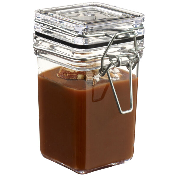 A Solia clear plastic jar with a lid filled with brown liquid.